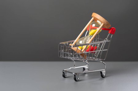 Hourglass in a shopping cart. Find balance to get the most out of each. Investing money can save you time. Fulfilling life and financial security. Hourly wages.