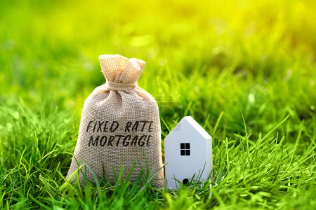 Photo for Fixed rate mortgage concept. Type of mortgage loan where the interest rate remains the same for the entire term of the loan. Real estate, finance and housing. Money bag - Royalty Free Image