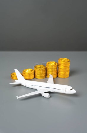 An airplane and a stack of coins symbolizing growth. Increase in income and flight efficiency. Savings on tickets, loyalty program.