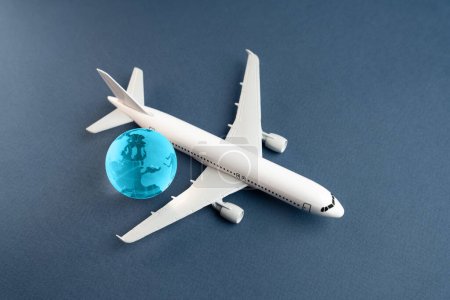 Airplane and blue globe. Construction of new airfields. Development of civil aviation. Travel and business trips. Transport system and infrastructure. Air communication. World flight routes.