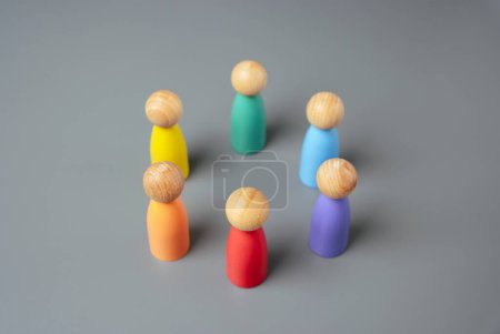 Multi-colored figures of people stand in a circle. Cooperation and unity of the LGBT+ community. Collaboration between members of the new team. Teamwork.