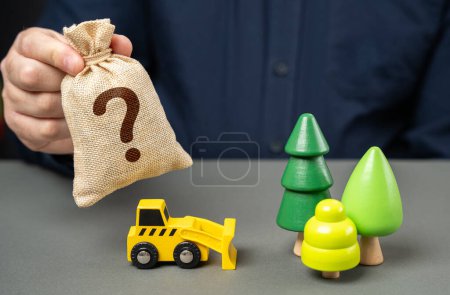 Bulldozer in the forest and a money bag with a question mark. A fair price for the sale of a forest plot. Sale of natural resources through auction. Corruption risks.