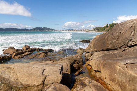 Photo for Waves, rocks and sand in Atalaia beach, Bombinhas, Santa Catarina, Brazil - Royalty Free Image