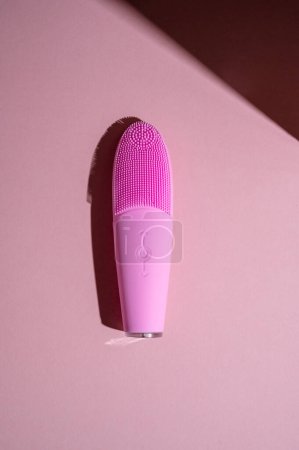 Photo for Pink silicone brush, face washing device. Beauty device. Deep cleanser and massager on pink background. - Royalty Free Image