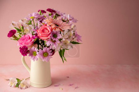 Photo for Beautiful fresh spring flowers. Pink bouquet of flowers in vase, on pink background - Royalty Free Image