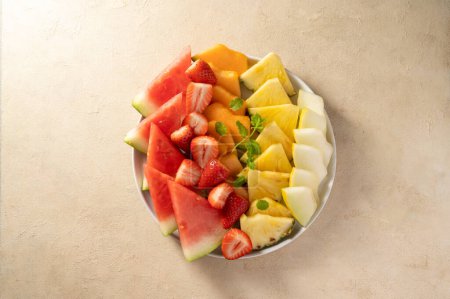 Summer, fresh fruits assortment platter, watermelon, pineapple, melon and strawberries. 