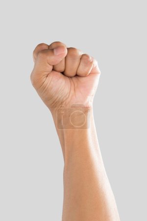 Photo for A man raising fist on a gray background. - Royalty Free Image