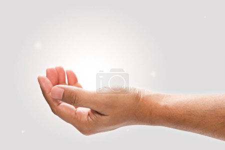 Photo for Male hand to hold something on a gray background. - Royalty Free Image