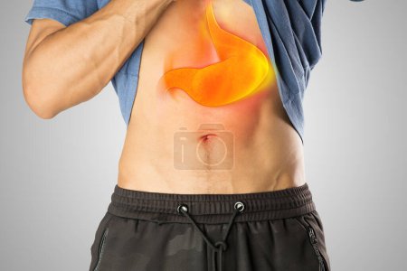 Photo for A man has a burning sensation in his chest because he has symptoms of acid reflux. - Royalty Free Image