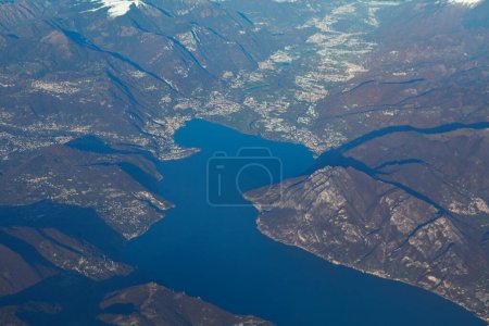 Photo for Lake Iseo and Alps view from the plane window . Scenic mountain views with lake in Italy - Royalty Free Image