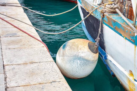 Photo for Fishing boats moored in the port . Nautical fender at harbor - Royalty Free Image
