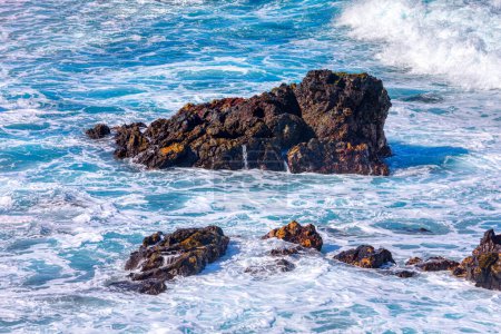 Photo for Massive rock stands in the midst of ocean waves, creating a captivating seascape. - Royalty Free Image