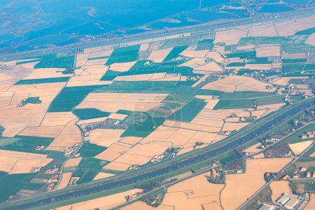 Aerial view of agricultural fields and farmlands. Shot in flight over the countryside.