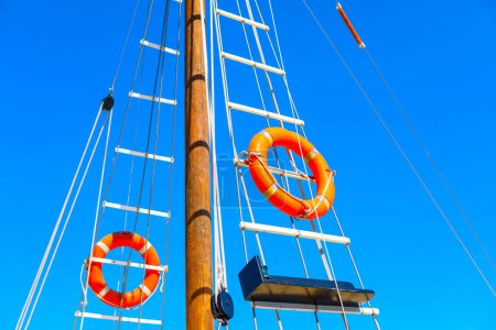 Lifebuoy on the rope mast on the boat