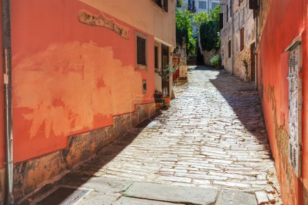 Narrow street in the old town of Pula, Croatia. Historic old quarter with narrow alley