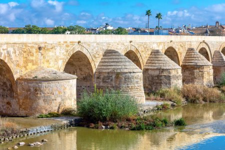 Photo for Roman bridge over Guadalquivir river in Cordoba, Spain. Ancient arch bridge over the river - Royalty Free Image