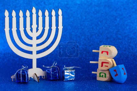 Jewish holiday Hanukkah concept. Menorah - traditional candelabrum or hanukkiah, and wooden dreidel - spinning top