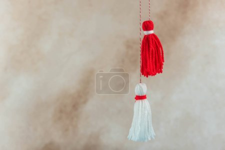 Traditional Martisor - symbol of holiday 1 March, Martenitsa, Baba Marta, beginning of spring and seasons changing in Romania, Bulgaria, Moldova. Greeting and post card for holidays.