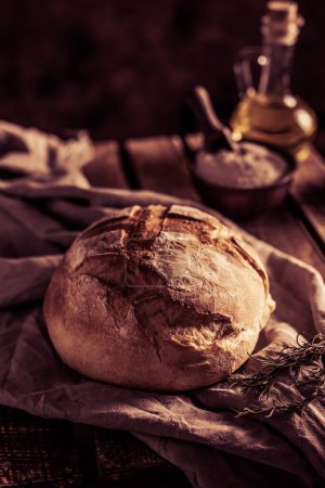 Photo for Homemade bread  and cloth napkin at wood table. Bakery concept still life and bread on wooden tabletop - Royalty Free Image