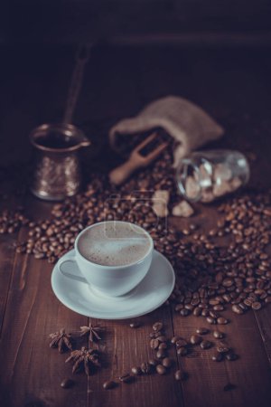 Photo for Cup of coffee and milk with beans on wooden table. Homemade coffee at table background - Royalty Free Image