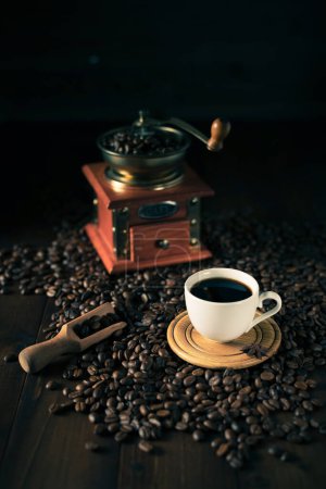 Photo for Cup of coffee and beans on wooden table. Homemade coffee at table background - Royalty Free Image