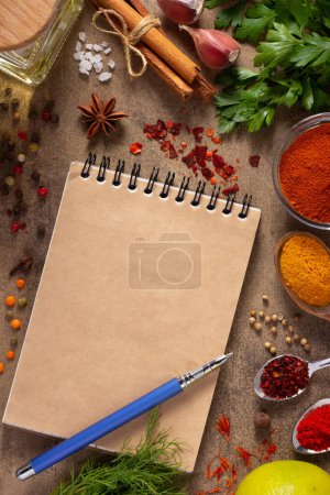 Photo for Cookbook and variety of spices and herbs on table background. Cooking concept and ingredients top view - Royalty Free Image