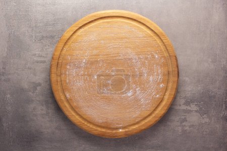 Photo for Pizza board at stone background top table. Wooden cutting board - Royalty Free Image