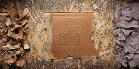 Photo for Cardboard torn edge and brown ripped paper at chipboard plywood background texture. Recycling concept and waste paper - Royalty Free Image