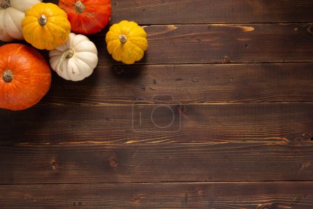 Photo for Pumpkin heap on wooden board table as autumn still life - Royalty Free Image