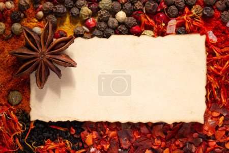 Photo for Variety of spices and ingredients with aged paper as cooking recipe concept closeup - Royalty Free Image