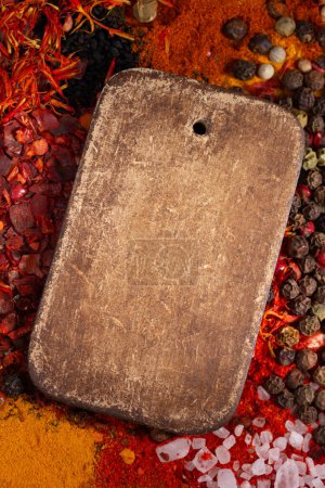 Photo for Variety of spices and wood tag price label on table background. Food spice and ingredients at kitchen table closeup - Royalty Free Image