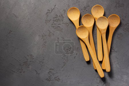 Photo for Emty wooden spoon on concrete stone table background - Royalty Free Image