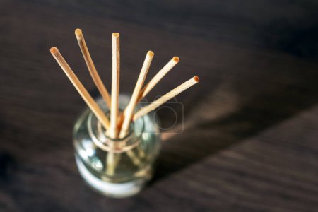 Photo for An aroma diffuser with aromatic oil and sticks in the room creates an atmosphere of peace and comfort - Royalty Free Image