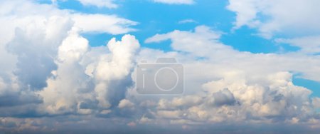 Photo for Blue sky with white curly cumulus clouds of various shapes - Royalty Free Image
