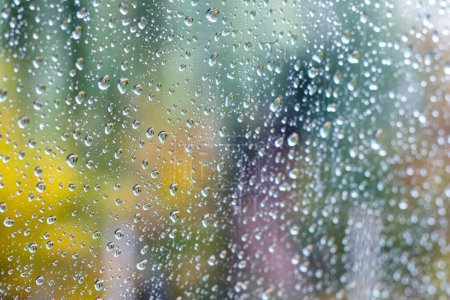 Photo for Water drops on the glass on a blurred autumn background - Royalty Free Image