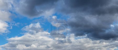 Blue sky with white and gray storm clouds