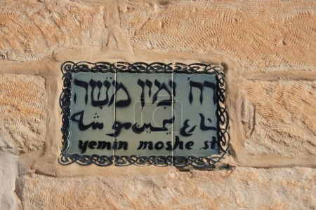 Photo for Yemin Moshe street sign in three Languages, Hebrew, English and Arabic at Yemin Moshe a historic neighborhood in Jerusalem, Israel overlooking the Old City. - Royalty Free Image