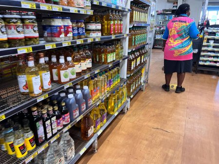 Photo for SEISIA, QLD - JUNE 16 2023:Torres Strait Islander woman shopping in supermarket.Torres Strait Islanders and Aboriginal Australians live in the Northern Peninsula area of Cape York - Royalty Free Image