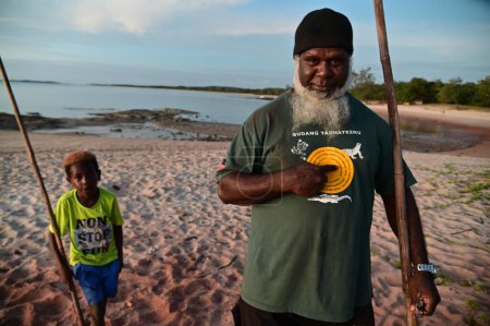 Photo for SEISIA, QLD - JUNE 16 2023:Torres Strait Islanders grandfather and grandchild.Land around the tip of Cape York have been recognized by a Federal Court judge as land and sea belong to native people. - Royalty Free Image
