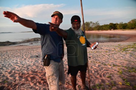 Photo for SEISIA, QLD - JUNE 16 2023:Torres Strait Islander showing Australian man the land around the tip of Cape York that have been recognized by a Federal Court judge as land and sea belong to native people. - Royalty Free Image