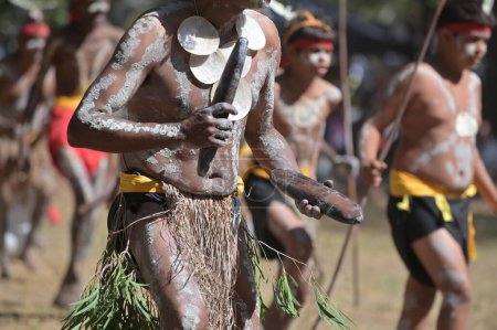 Photo for LAURA,QLD - JULY 08 2023:Indigenous Australian men holding traditional weapons during a ceremonial dance in Laura Quinkan Dance Festival Cape York Australia. Ceremonies combine dance, song, rituals, body decorations and costumes - Royalty Free Image