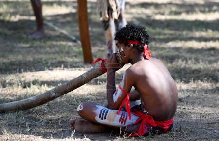 Photo for LAURA,QLD - JULY 08 2023:Indigenous Australian man play didgeridoo on ceremonial dance in Laura Quinkan Dance Festival Cape York Australia. Ceremonies combine dance, song, rituals, body decorations and costumes - Royalty Free Image