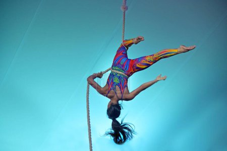 Photo for GOLD COAST - FEB 17 2024:Female rope acrobat on acrobatics performance.In China, acrobatics have been a part of the culture since the Tang dynasty (203 BC). - Royalty Free Image