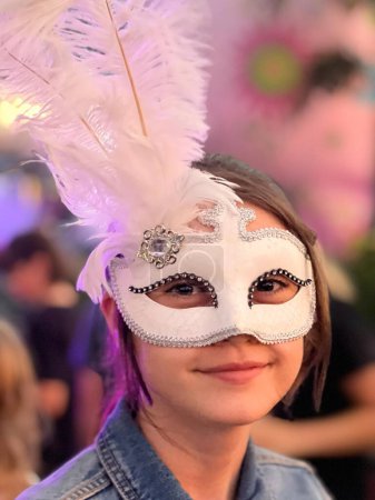 Photo for Beautiful teen age girl (female age 14) wearing a Venetian mask on carnival party. - Royalty Free Image