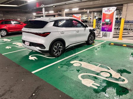 Photo for BRISBANE - JAN 10 2024:Electric Vehicle (EV) charging in Supercharger station.Australia currently has less than 3,500 public charging stations, of which approximately 470 are fast charging. - Royalty Free Image