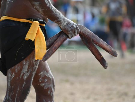 LAURA,QLD - JULY 08 2023:Indigenous Australians man holding boomerang on ceremonial dance in Laura Festival Cape York Australia. Ceremonies combine dance, song, rituals, body decorations and costume.