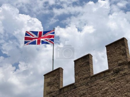 Photo for National flag of the United Kingdom fly on castle. - Royalty Free Image