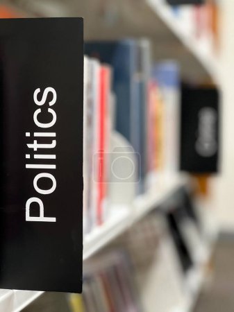 Photo for Politics sign on a political books shelf in a local public library. - Royalty Free Image