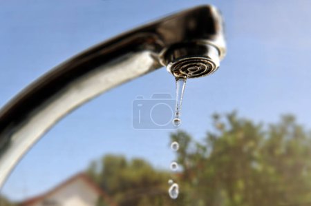 Photo for Leaky water tap in home kitchen. Concept photo of water waste. - Royalty Free Image