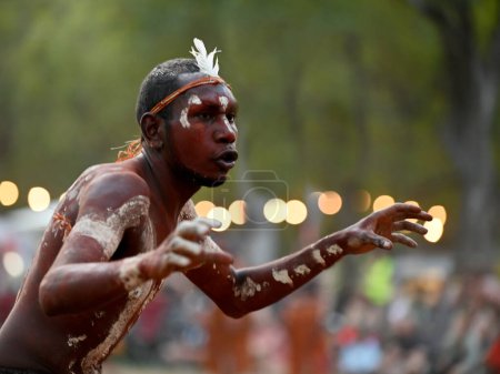 LAURA,QLD - JULY 08 2023:Indigenous Australians man on ceremonial dance in Laura Quinkan Dance Festival Cape York Australia. Ceremonies combine dance, song, rituals, body decorations and costumes